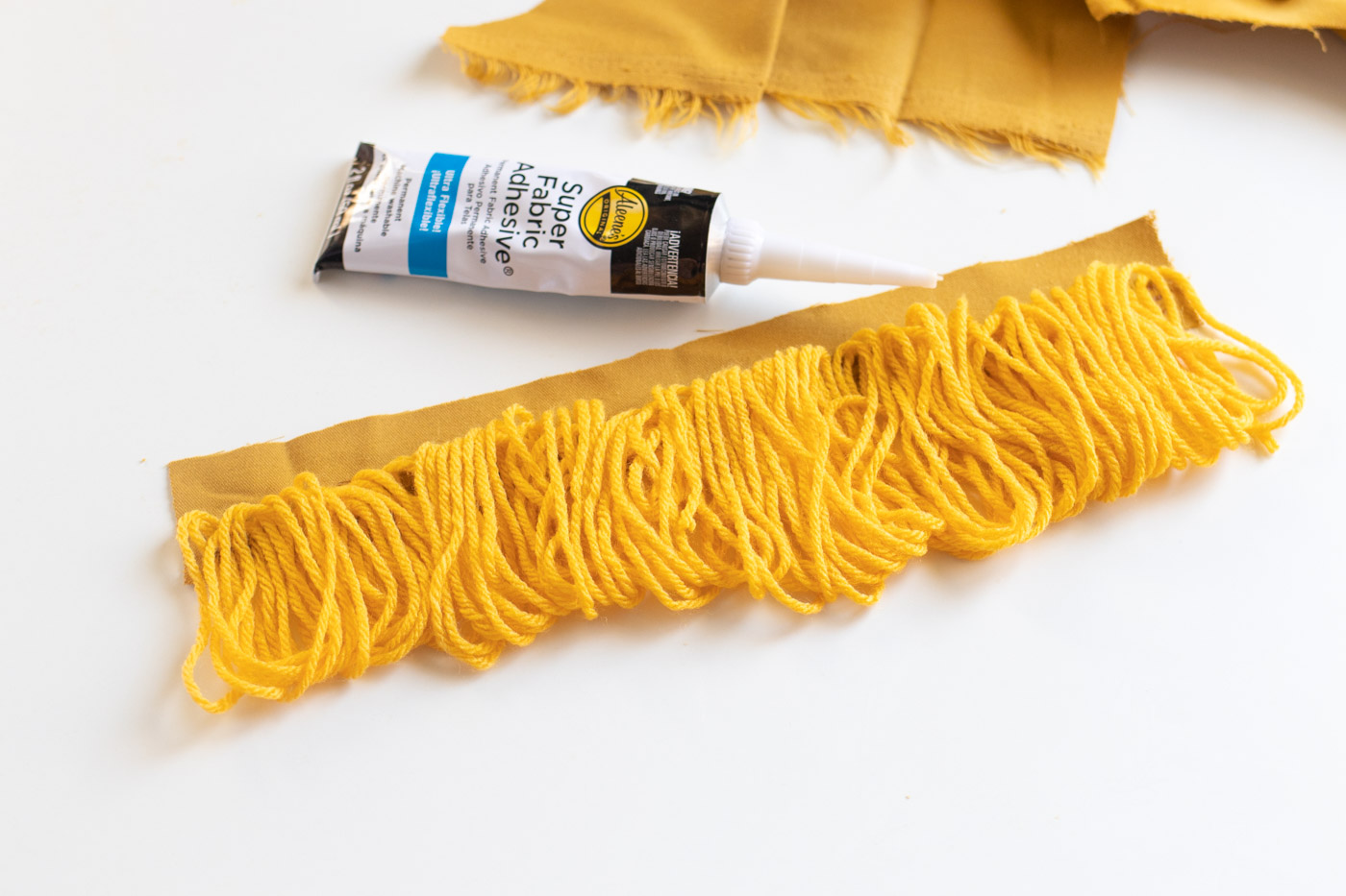 DIY No-Sew Boho Fringe Pillow /// Tutorial by Club Crafted for Design Fixation #colorful #fabric #tassels